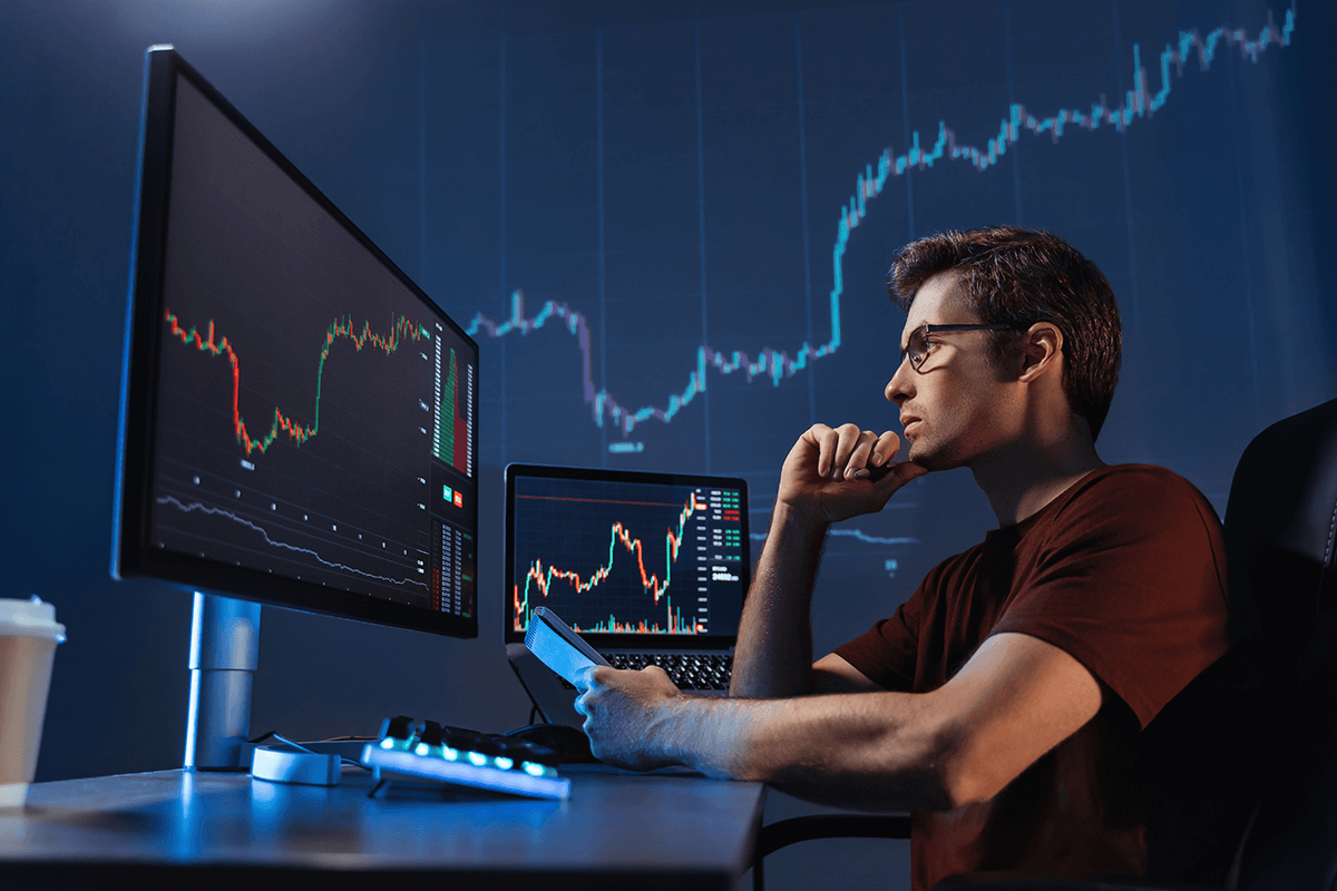 crypto-trader-sitting-in-front-of-computers